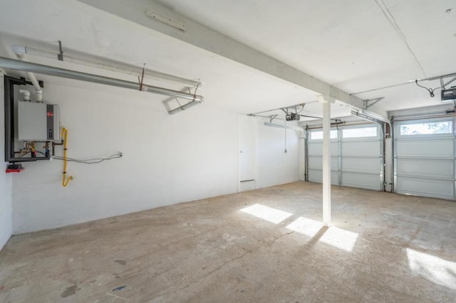 garage featuring tankless water heater and a garage door opener