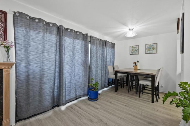 dining space with hardwood / wood-style floors