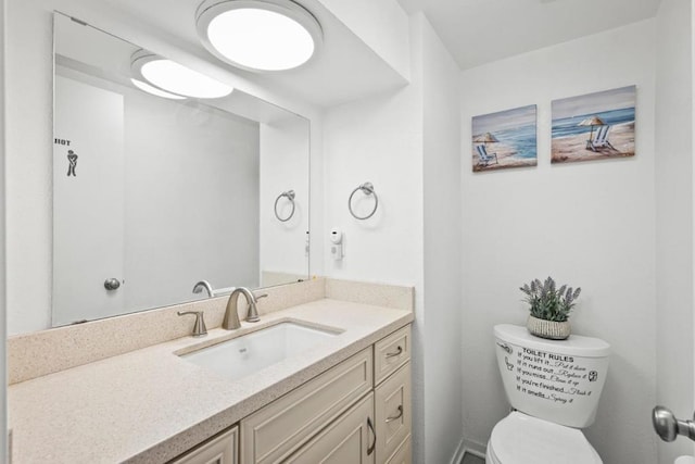 bathroom featuring toilet and vanity