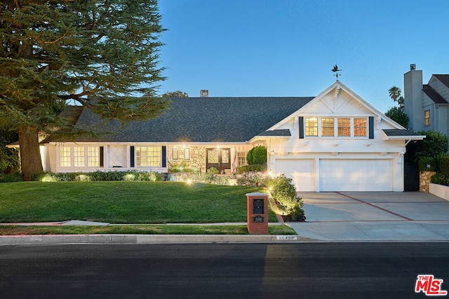 view of front of house with a garage and a front yard