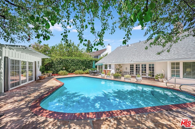 view of pool featuring french doors and a patio