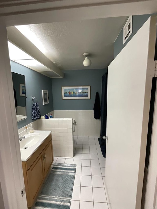 bathroom with vanity, tile patterned flooring, and a textured ceiling