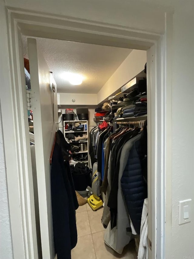 spacious closet with light tile patterned floors