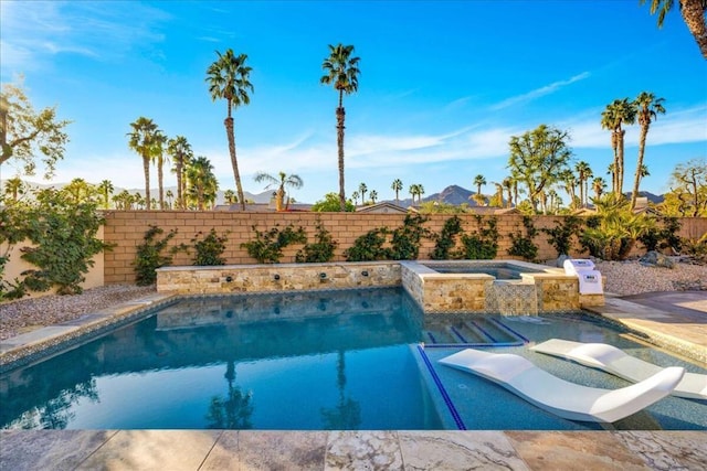 view of pool with an in ground hot tub