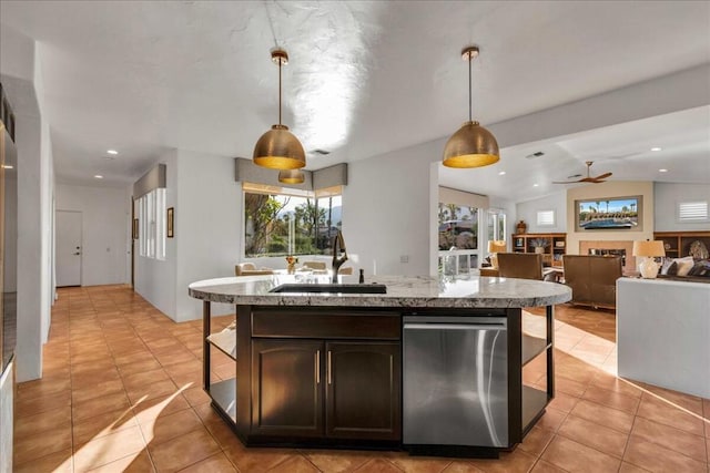 kitchen featuring sink, hanging light fixtures, dark brown cabinets, a center island with sink, and dishwasher