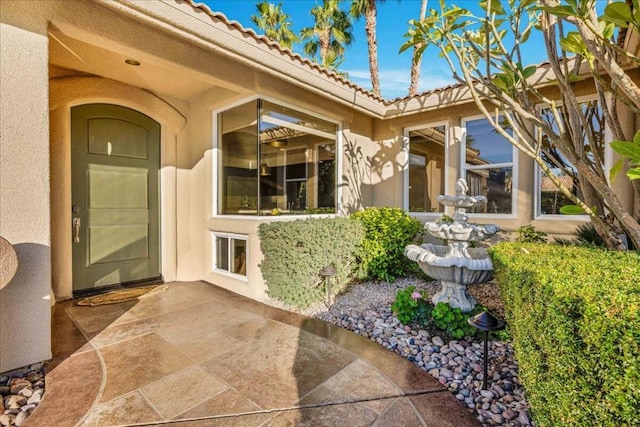 entrance to property featuring a patio area