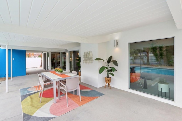 sunroom featuring beam ceiling