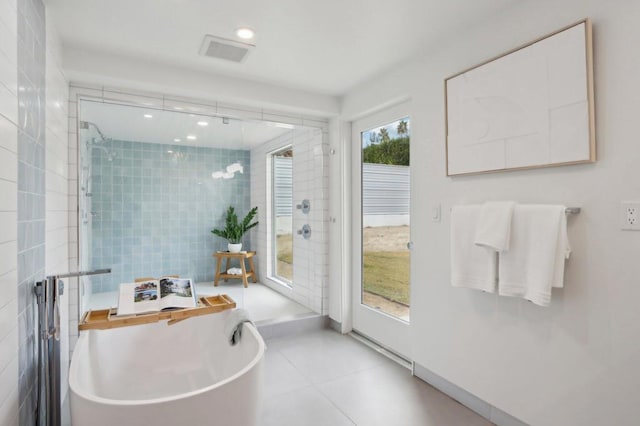 bathroom featuring tile patterned flooring and shower with separate bathtub