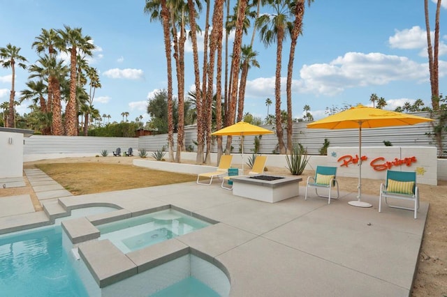 view of pool featuring an outdoor fire pit, an in ground hot tub, and a patio