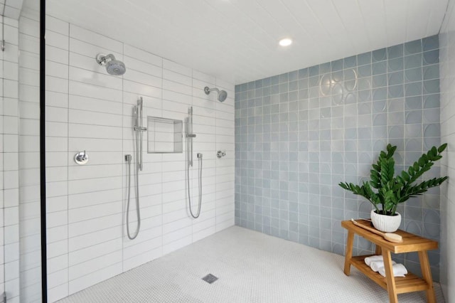 bathroom featuring tile walls and tiled shower