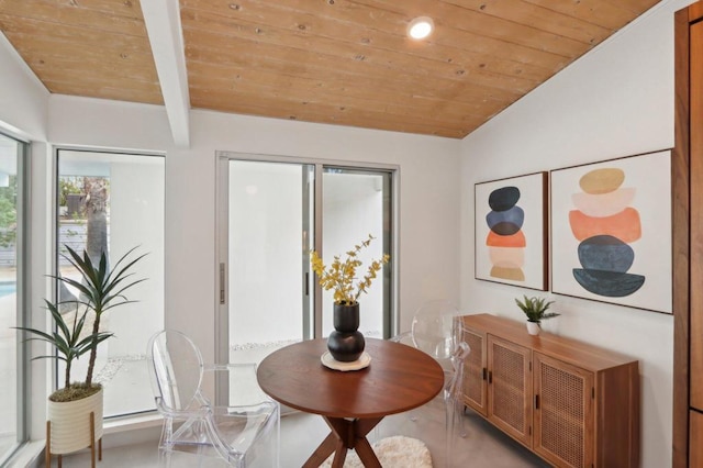 dining area with wooden ceiling and lofted ceiling with beams