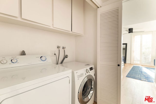 laundry room featuring ceiling fan, cabinets, independent washer and dryer, and light hardwood / wood-style floors