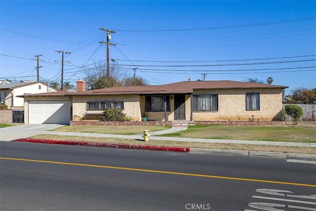 single story home with a front yard and a garage