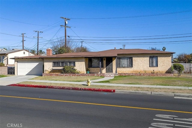 single story home featuring a front lawn, a garage, driveway, and stucco siding