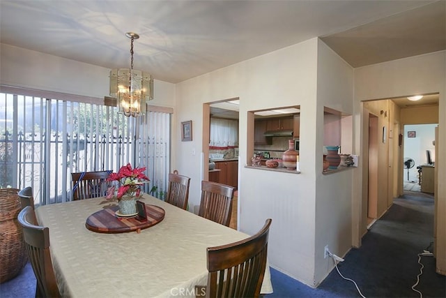 carpeted dining space featuring a notable chandelier