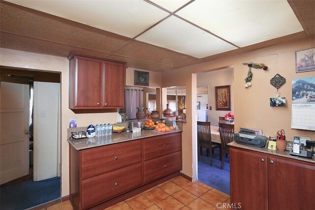 kitchen with light tile patterned floors and a drop ceiling