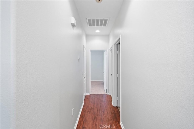 corridor with dark wood-type flooring