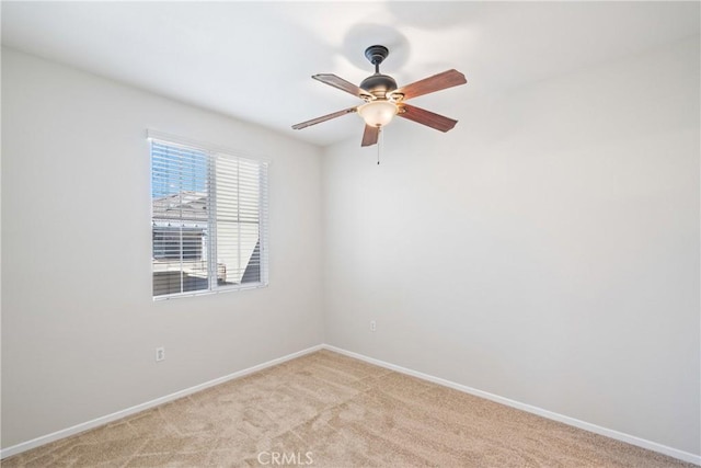 unfurnished room featuring ceiling fan and light colored carpet