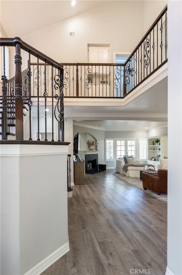 interior space with wood-type flooring and high vaulted ceiling