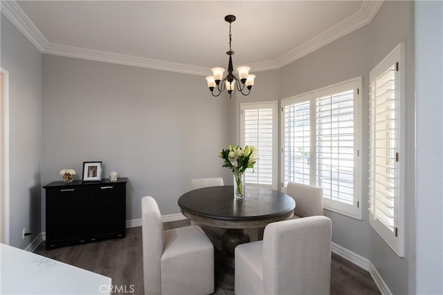 dining room with dark hardwood / wood-style floors, an inviting chandelier, and ornamental molding