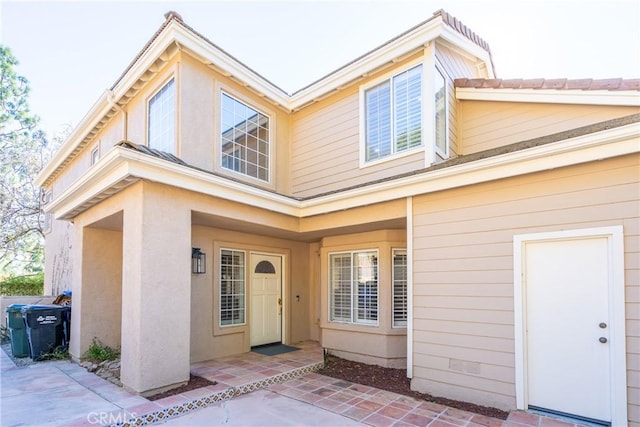 property entrance with a patio