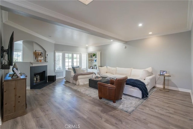 living room with hardwood / wood-style floors and crown molding