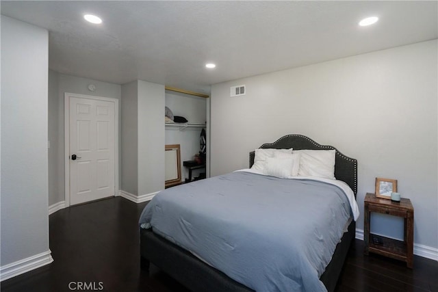 bedroom with a closet and dark hardwood / wood-style floors