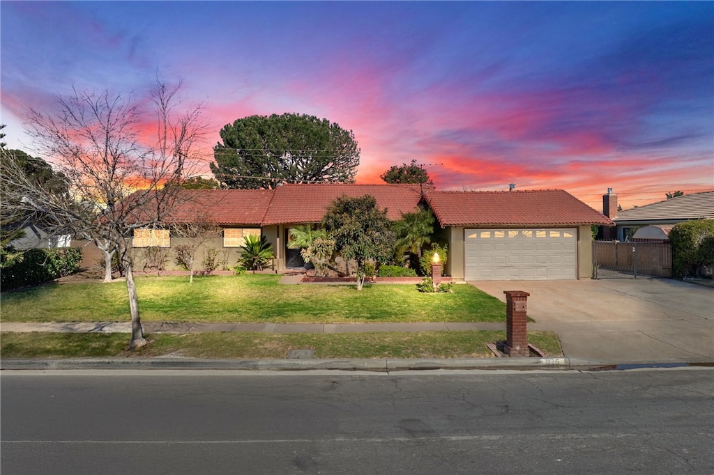 view of front of house with a garage and a lawn