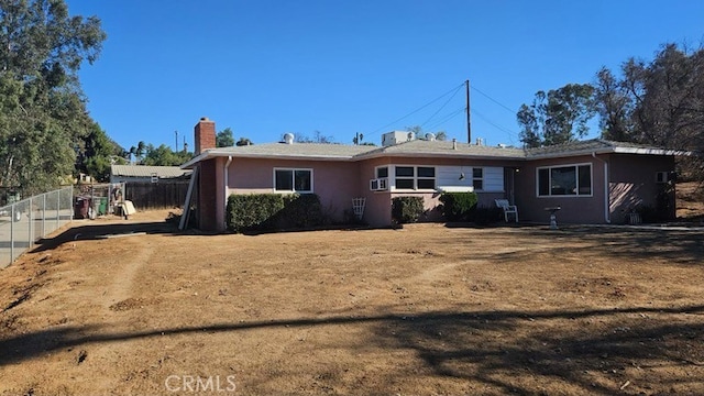 rear view of house with a lawn