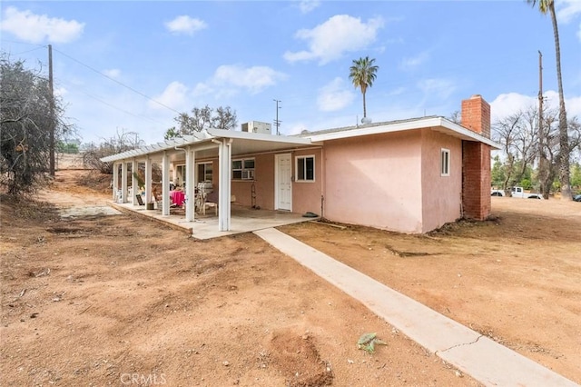 back of property with a patio