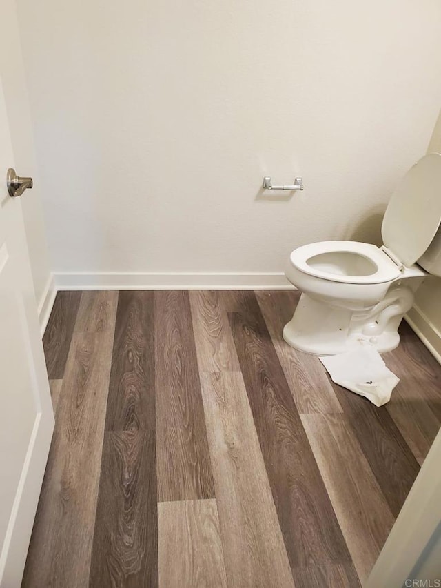 bathroom with toilet and wood-type flooring