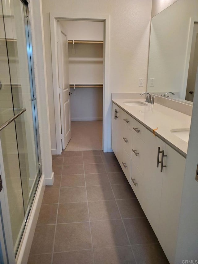 bathroom with vanity, tile patterned floors, and walk in shower