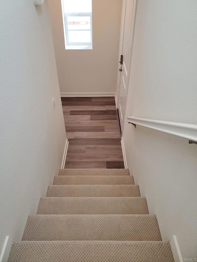 staircase featuring hardwood / wood-style flooring