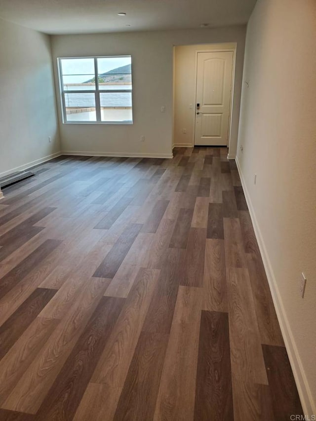 spare room featuring dark hardwood / wood-style flooring