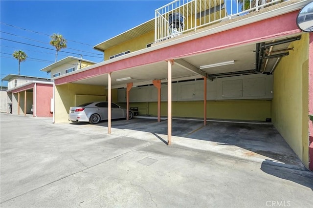 view of parking / parking lot featuring a carport