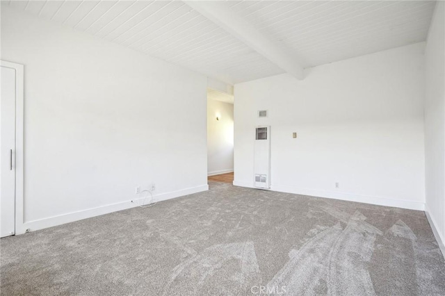 unfurnished room featuring carpet and beamed ceiling