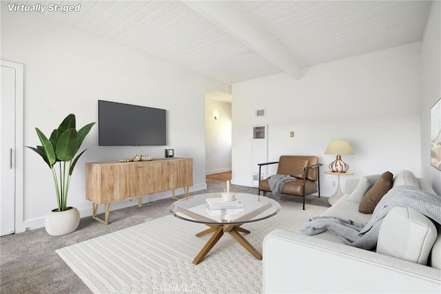 carpeted living room with beam ceiling