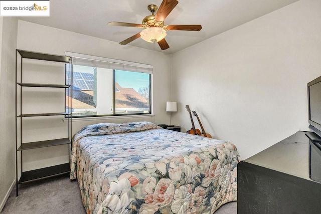 bedroom featuring ceiling fan and light carpet