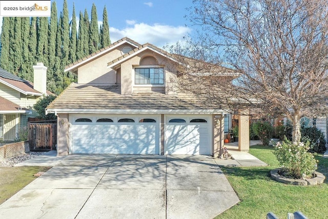 exterior space with a garage and a front lawn