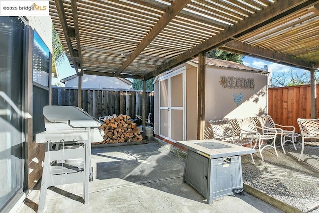 view of patio with a storage unit, area for grilling, and a pergola