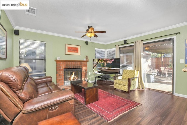 living room featuring ceiling fan, dark wood-type flooring, and crown molding