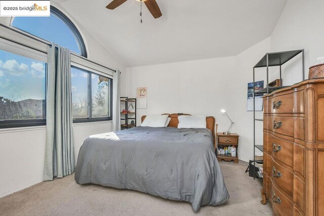 carpeted bedroom with ceiling fan and lofted ceiling