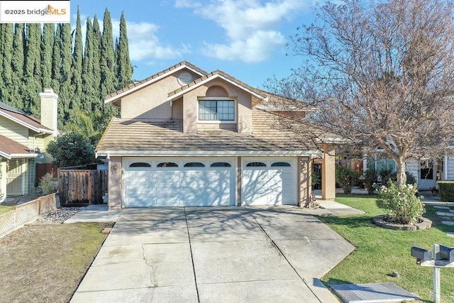 view of front facade with a front yard and a garage