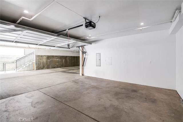 garage featuring a garage door opener and electric panel