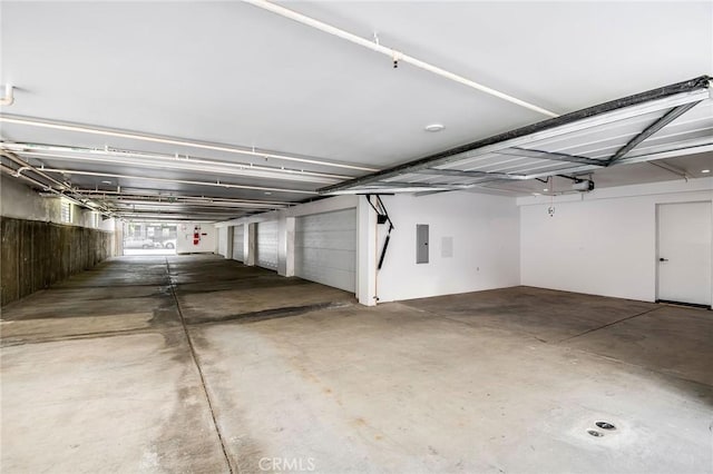 garage with a garage door opener and electric panel