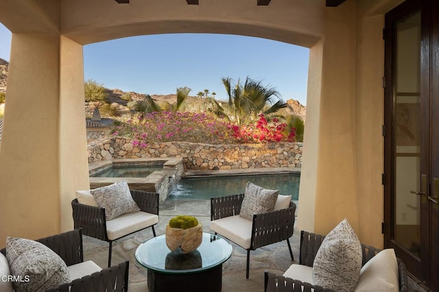 balcony featuring an in ground hot tub, a patio area, and ceiling fan