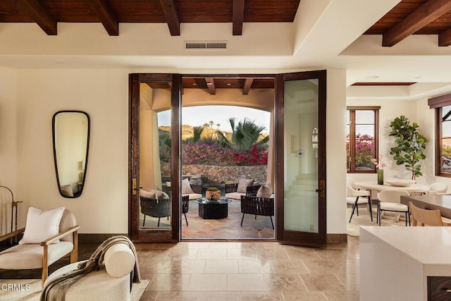 entryway featuring wooden ceiling and beam ceiling