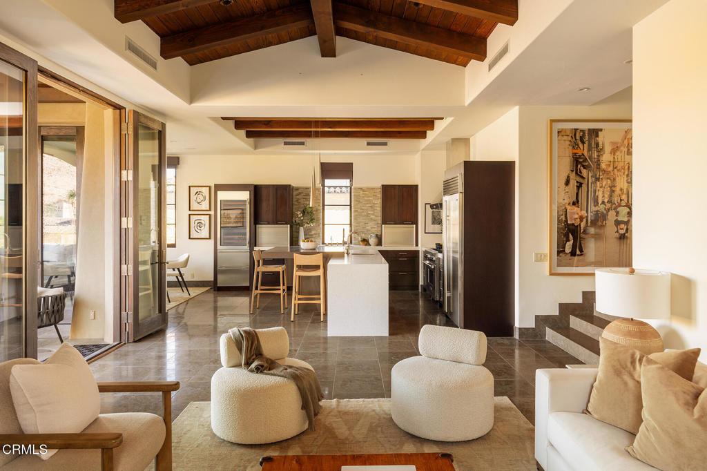 living room with a healthy amount of sunlight, wood ceiling, high vaulted ceiling, and beamed ceiling