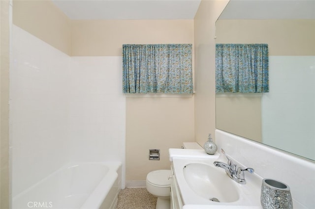 bathroom with a tub, sink, and toilet