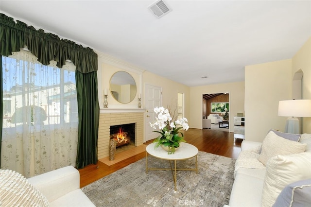 living room with hardwood / wood-style flooring and a fireplace